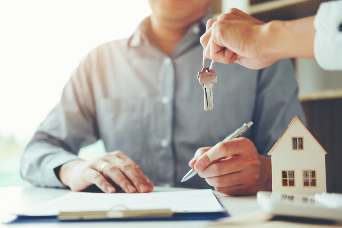 Sale agent giving Key house to customer and sign agreement contr