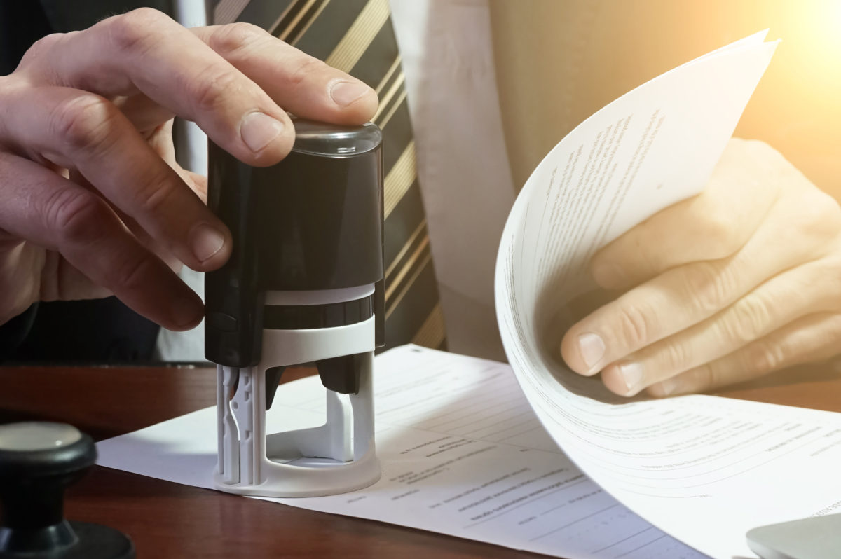The businessman puts a stamp on the contract