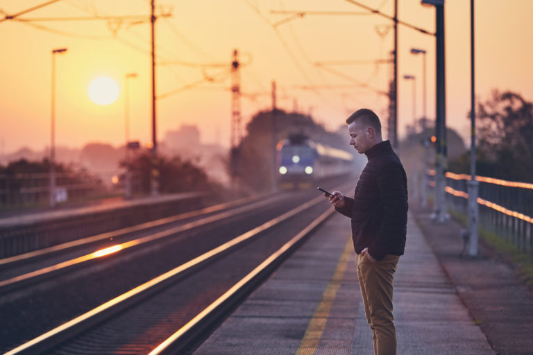 Man waiting at railroad station