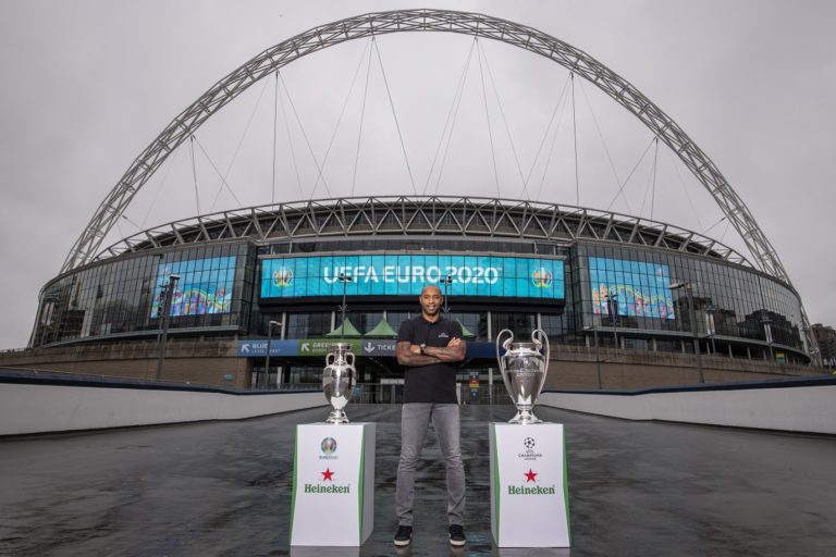 Henry with euro and ucl trophy with wembley arch backdrop 2.jpg