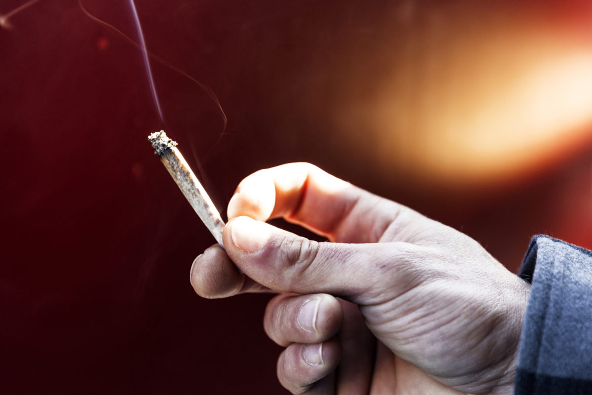 Young Man Passing Marijuana Joint