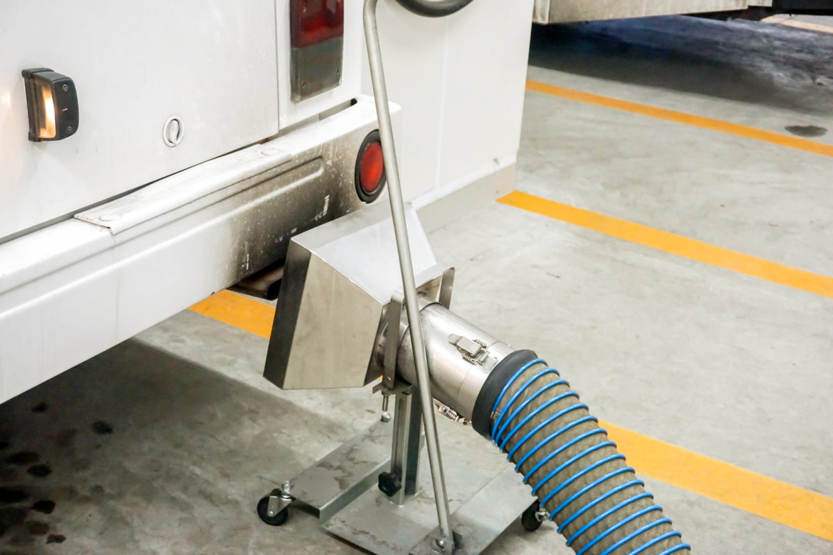 Closeup gas dispensing head and filling liquid propane gas to the bus at gas station service.