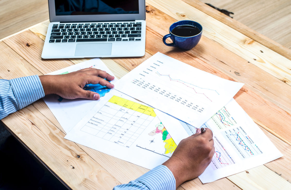 Businessman analyzing investment charts with laptop. Accounting