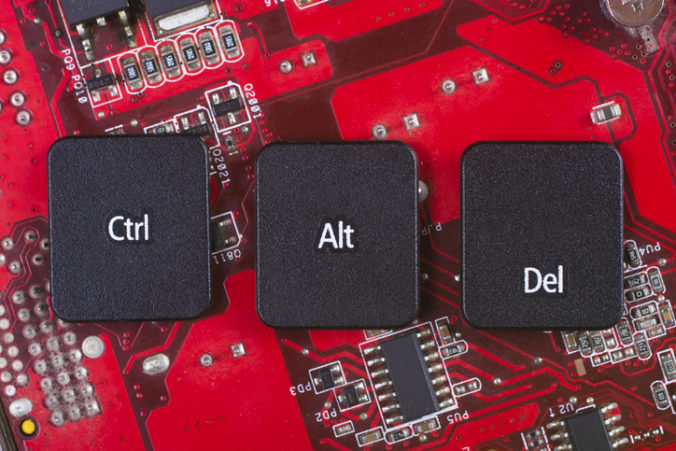 Keyboard keys form the word CTRL ALT CANC on red electric circuit in the background.