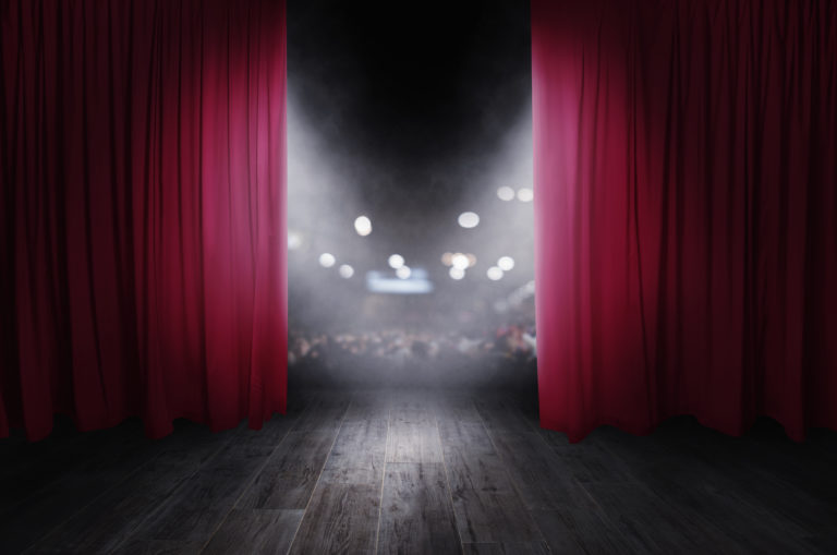 The red curtains are opening for the theater show