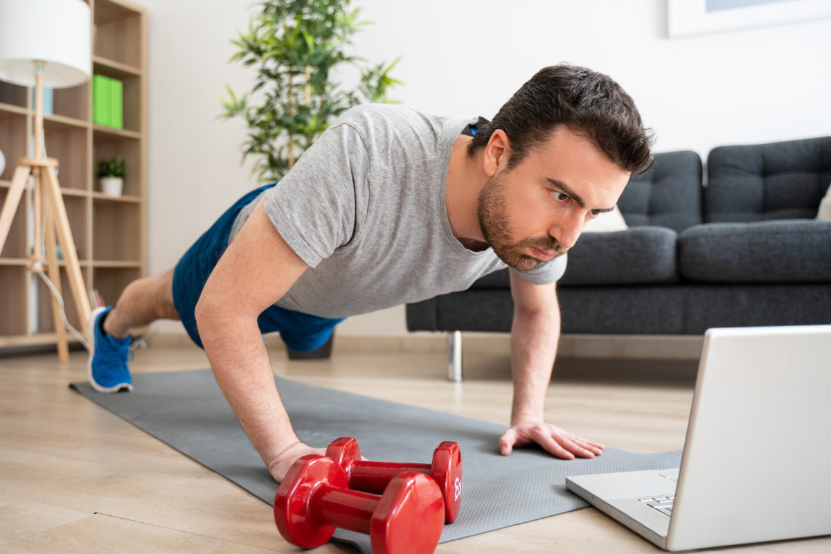 Man watching online training with laptop at home