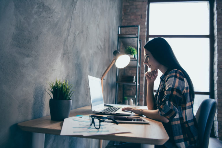 Profile side view of her she nice lovely charming attractive executive manager brunette lady checked shirt preparing marketing review report at industrial loft style interior room work place station