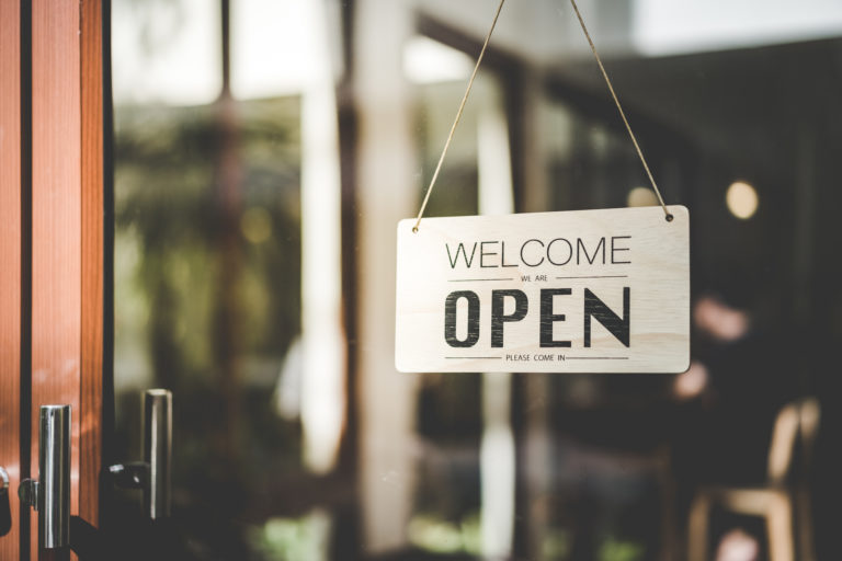 Open sign hanging front of cafe with colorful bokeh light abstract background. Business service and food concept. Vintage tone filter effect color style.