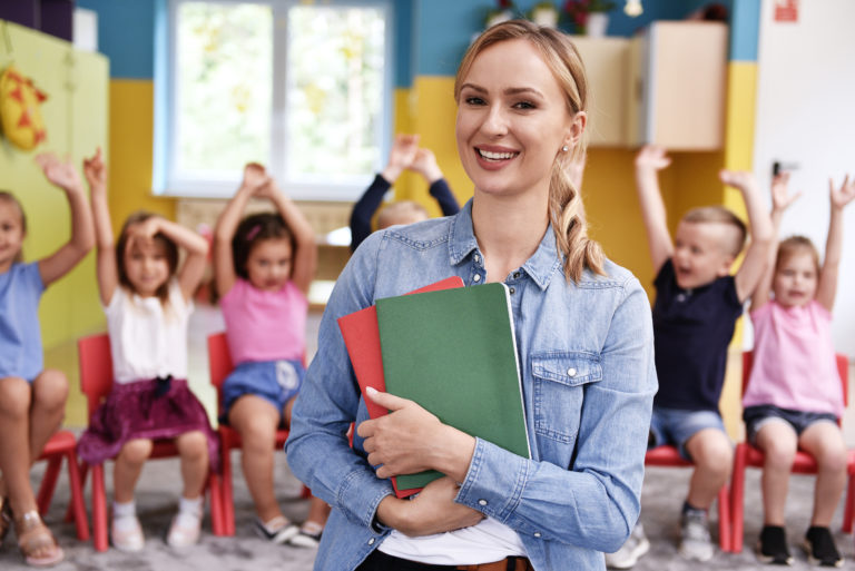 Smiling female teacher in the preschool