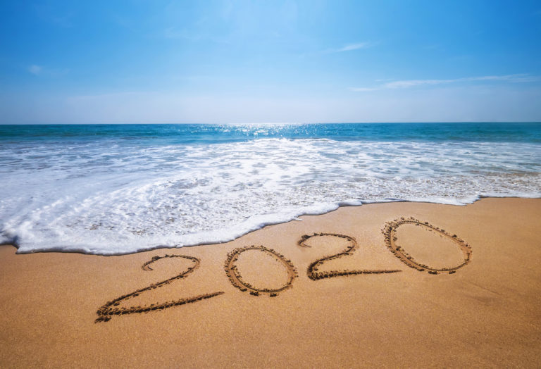 Happy New Year 2020 is coming concept sandy tropical ocean beach lettering. Exotic New Year celebration concept image.