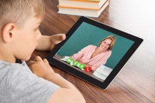 Boy Videoconferencing On Digital Tablet