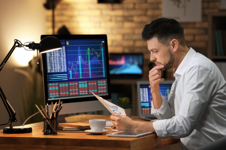 Young stock exchange trader working in office