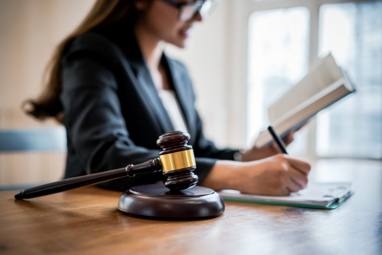 Lawyer business women consultant reading and writing on a note in office. Law, legal services, advice, consult, Justice concept.
