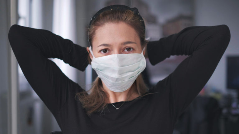 Horizontal background of woman wearing surgical mask for corona virus isolation