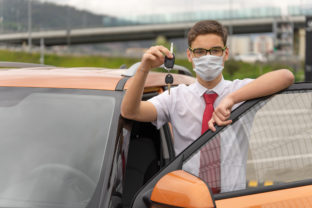 Concept of a personal driver service. Chauffeur drive. Personal chauffeur in a protective face mask