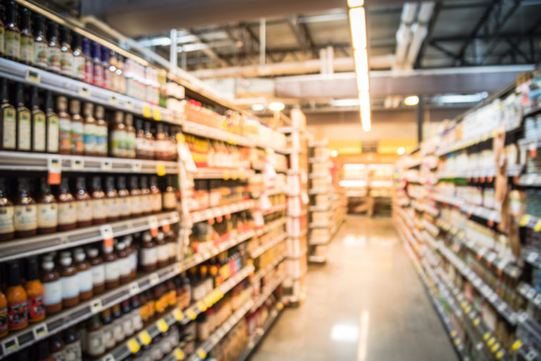 Blurry background variety of canned vegetables at grocery store in America