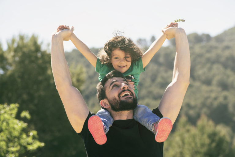 Father and baby girl playing outdoors