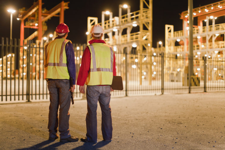 Workers standing together in shipyard