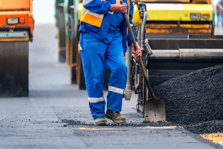 The workers and the asphalting machines