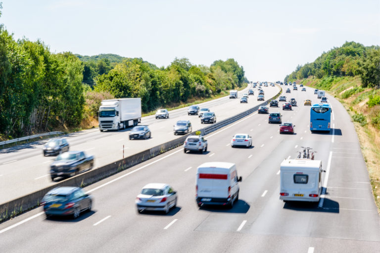 Heavy but fluid traffic on the A10 highway in France by a sunny day.