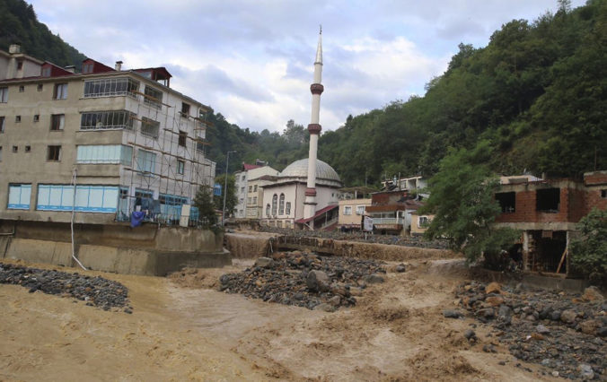 The road has been swept away and debris strewn across the area after floods caused by heavy rain in the mountain town of Dereli in Giresun province, along Turkey's Black Sea coastline, Sunday, Aug. 23, 2020. Interior Minister Suleyman Soylu said four people have died and 11 people are still missing after flooding around Dereli.(AP Photo)