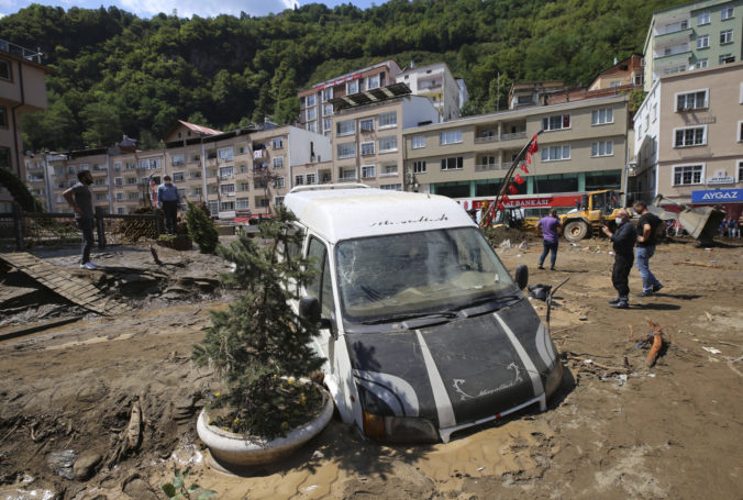 People inspect the destruction after floods caused by heavy rain in the mountain town of Dereli in Giresun province, along Turkey