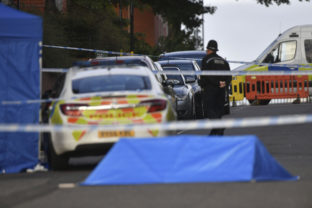 A police officer and vehicles are seen at a cordon in Irving Street in Birmingham after a number of people were stabbed in the city centre, Sunday, Sept. 6, 2020. British police say that multiple people have been injured in a series of stabbings in a busy nightlife area of the central England city of Birmingham.