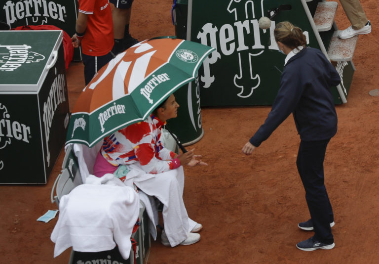Victoria Azarenka of Belarus complains about the weather conditions and ask the umpire to suspend the first round match of the French Open tennis tournament against Montenegro's Danka Kovinic at the Roland Garros stadium in Paris.