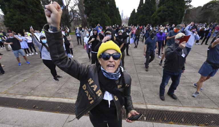People gather at a so-called "Freedom Day" protest in Melbourne, Saturday, Sept. 5, 2020. Police in Australia's hardest-hit Victoria state are urging people to stay away from rallies protesting the lockdown in Melbourne.