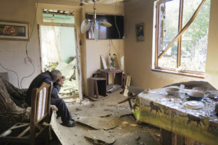 Yury Melkonyan, 64, sits in his house damaged by shelling from Azerbaijan's artillery during a military conflict in Shosh village outside Stepanakert, the separatist region of Nagorno-Karabakh, Saturday, Oct. 17, 2020. The latest outburst of fighting between Azerbaijani and Armenian forces began Sept. 27 and marked the biggest escalation of the decades-old conflict over Nagorno-Karabakh. The region lies in Azerbaijan but has been under control of ethnic Armenian forces backed by Armenia since the end of a separatist war in 1994. ()