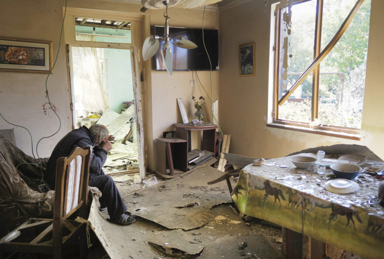 Yury Melkonyan, 64, sits in his house damaged by shelling from Azerbaijan's artillery during a military conflict in Shosh village outside Stepanakert, the separatist region of Nagorno-Karabakh, Saturday, Oct. 17, 2020. The latest outburst of fighting between Azerbaijani and Armenian forces began Sept. 27 and marked the biggest escalation of the decades-old conflict over Nagorno-Karabakh. The region lies in Azerbaijan but has been under control of ethnic Armenian forces backed by Armenia since the end of a separatist war in 1994. ()