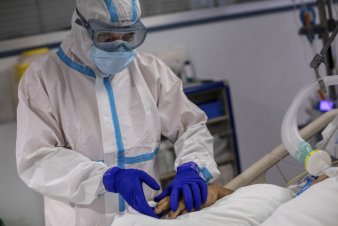 A patient infected with COVID-19 is treated in one of the intensive care units (ICU) at the Severo Ochoa hospital in Leganes, outskirts of Madrid, Spain, Friday, Oct. 9, 2020. At the peak of the first wave, ICU wards were given over to haste, desperation and even cluelessness about what to do. Now, a well-oiled machinery saves some lives and loses others to coronavirus, but without the doomsday atmosphere of March and April. (AP Photo/Bernat Armangue)