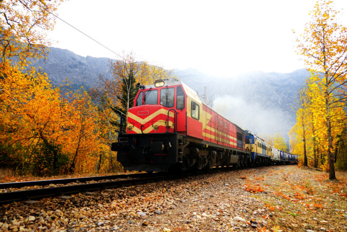 Passenger Train in countryside landscape with colorful autumn leaves and trees