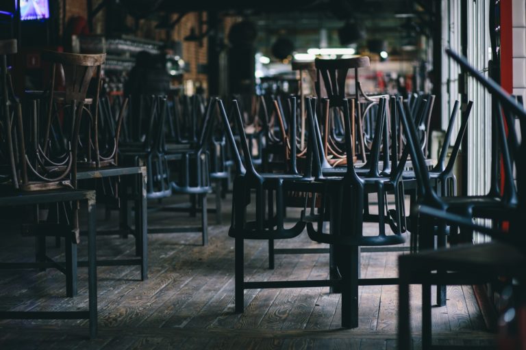 Chairs and tables stacked in a closed pub