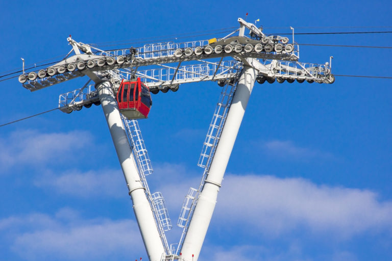 Cable car against the blue sky with clouds. Funicular.