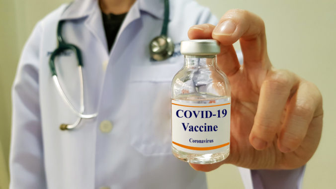 Infectious doctor show COVID 19 vaccine for prevention,immunization and treatment for new corona virus infection(COVID 19,novel coronavirus disease 2019 or nCoV 2019 from Wuhan). Medical technology.