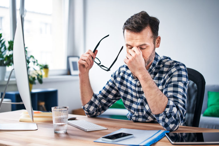 Frustrated, overworked freelancer working from home office