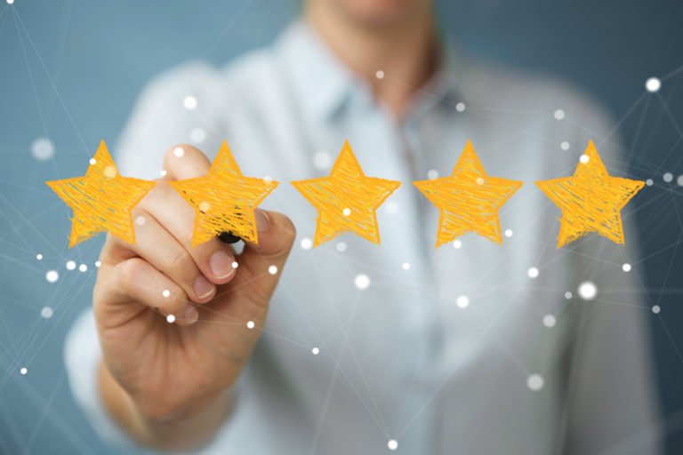 Businesswoman on blurred background rating with hand drawn stars