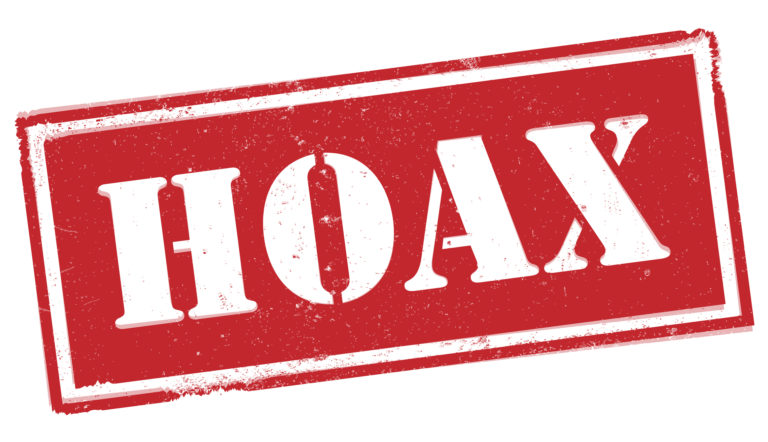 Red grungy HOAX label or stamp isolated on white background