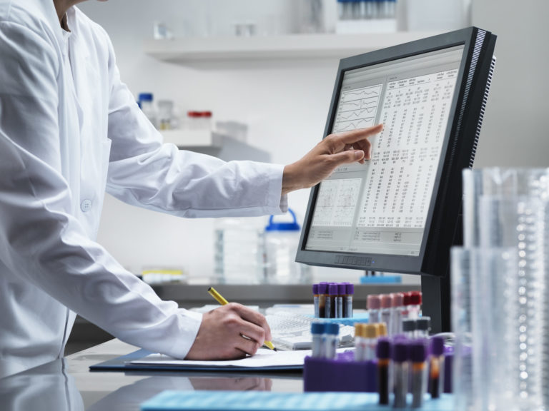 Scientist using computer in lab