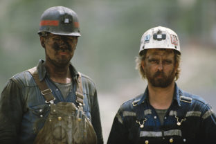 Portrait of two soiled hard working caucasian coal miners