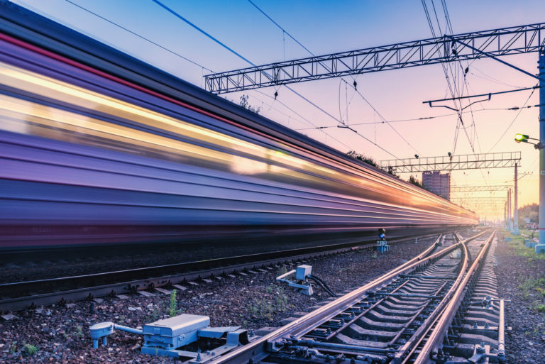 Two trains move fast to the different directions.