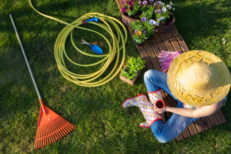 Woman,Having,A,Coffee,Break,While,Working,In,The,Garden,