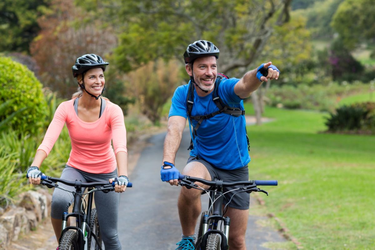 Athletic couple pointing while riding bicycle.jpg