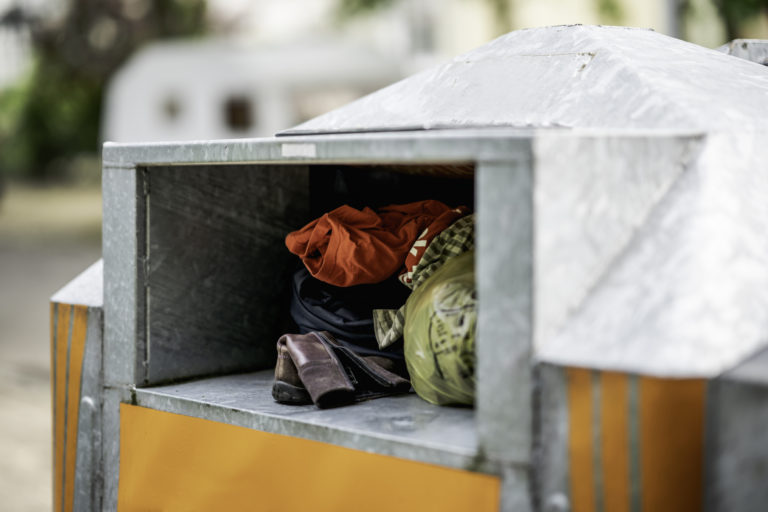 Worn clothes in a container