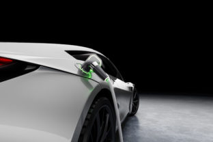 E Mobility and ecology. Charging an electric sports car with black background. Charging battery concept. 3D rendering.