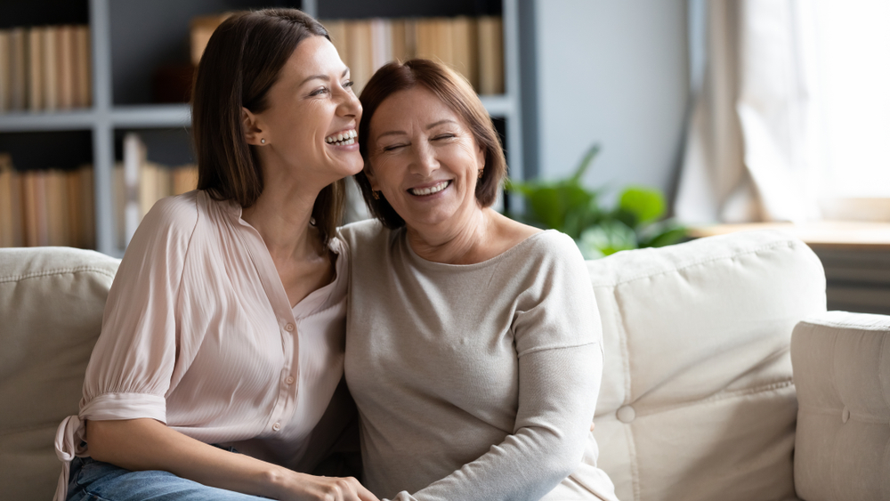 Happy,Senior,Mother,And,Grownup,Daughter,Sit,Relax,On,Couch