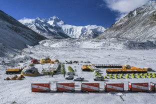 FILE - In this April 30, 2020, aerial file photo released by China's Xinhua News Agency, vehicles and tents are seen at the base camp at the foot of the Chinese side of the peak of Mount Qomolangma, also known as Mount Everest, in southwestern China's Tibet Autonomous Region. China has canceled attempts to climb Mount Everest from its side of the world's highest peak because of fears of importing COVID-19 cases from neighboring Nepal, state media reported. (