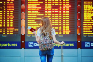 Tourist girl with backpack in international airport