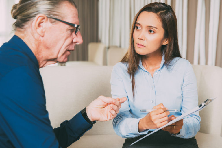Serious Young Woman Interviewing Senior Man